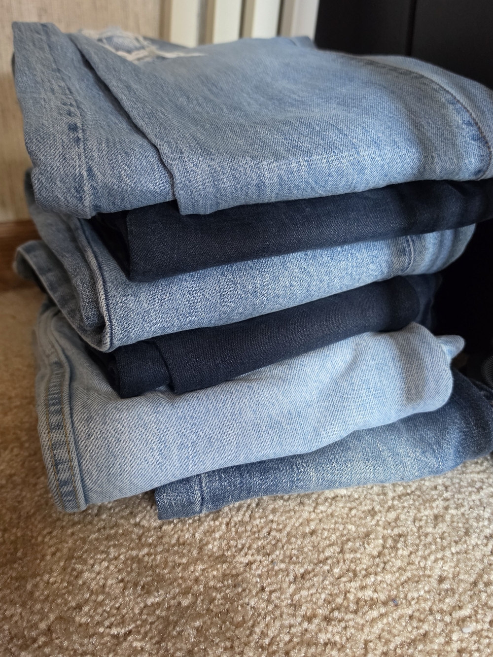 Stack of Blue And Black Denim Jeans
